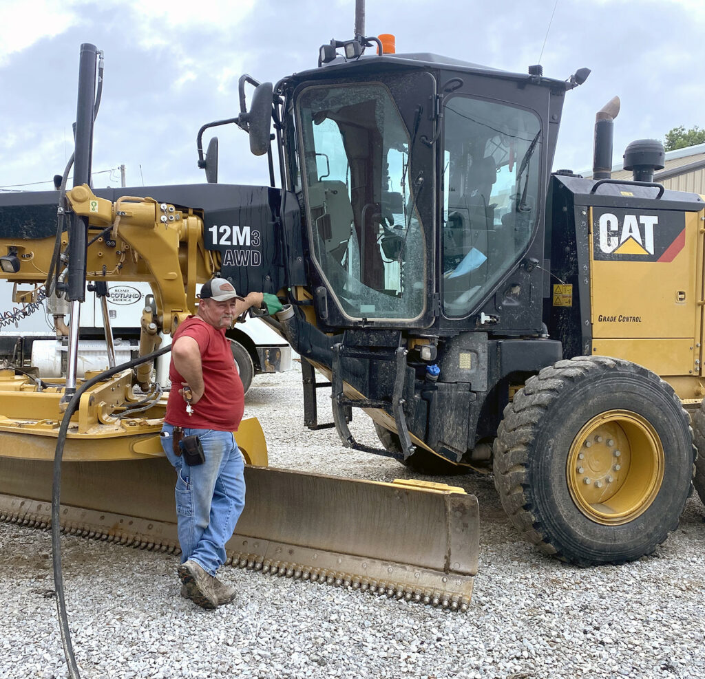 An employee of Scotland County’s Road and Bridge crew fills up one of the county’s fleet, a Caterpillar 12 M3 Motor Grader, with B20 biodiesel from its depot in Memphis, Mo. Scotland County began using B20 biodiesel in its county fleet for the first time this year.